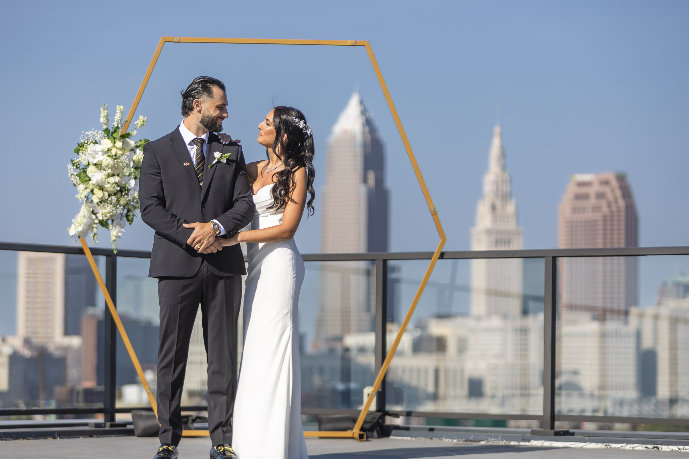 bride and groom portrait with the cleveland skyline in the background